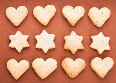 Holiday cookies as a background pattern on brown