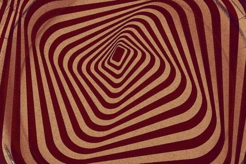 Retro background from a twisted spiral with cracks and scratches.vintage geometric with swirling