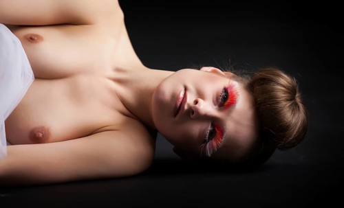 Female beauty portrait with tutu in front of a dark background