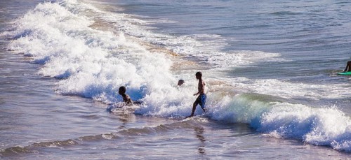 People swim, surf and play in the water