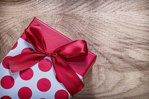 Red present box on wooden board celebrations concept