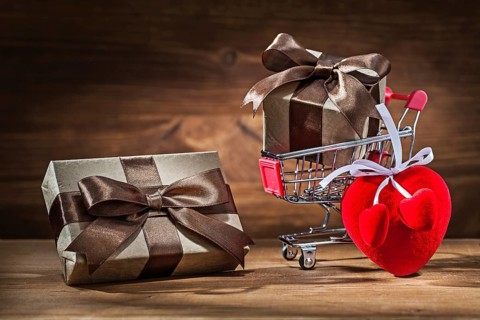 Two vintage gift boxes in shopping cart and heart toy