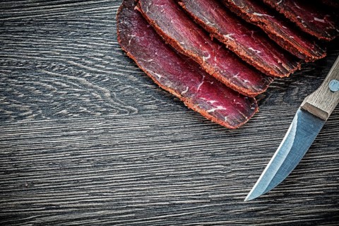 Sliced meat knife on wooden board