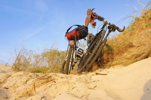 Two bicycles on the sea sand, a Bicycle in the sunset rays, Curonian spit, Zelenograd district,