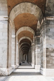 Madrid, Spain, May 16, 2023: Arcade of Royal Palace in Madrid in a sunny spring day, Europe