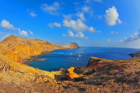 White yachts lit sunset. Quiet ocean cove on the island of Madeira. Calm on the Atlantic Ocean