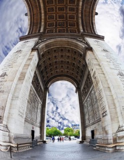 The striking and unexpected angle Arc de Triomphe in Paris. Background - the cloudy sky. Photo was