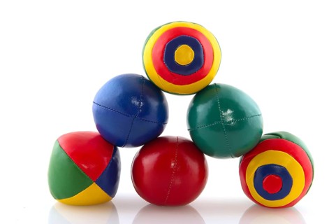 Many colorful juggle balls with stripes isolated over white