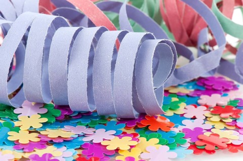 Paper colorful party streamers on tiny flowers