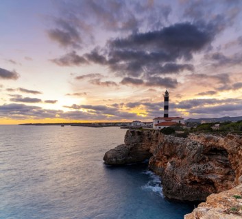 A view of the Portocolom Lighthouse in eastern Mallorca at sunset