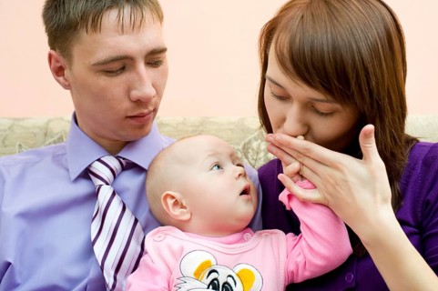Young caucasian couple with their little baby