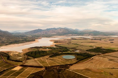 Fields, irrigation basin, river, clouds, sky, dirt road, meadows, bushes, mountains,