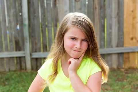 Kid girl with disappoint expression finger thinking expression outdoor