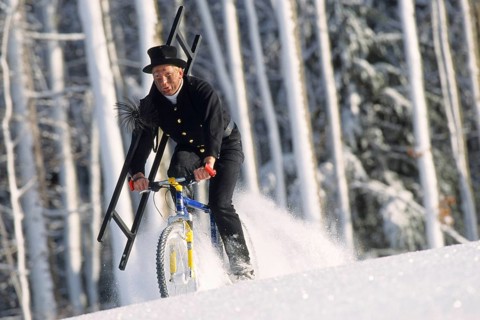 Chimney sweep on a mountain bike in winter, chimney sweep, chimney sweep