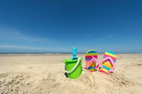 Summer beach with toys and flip flops