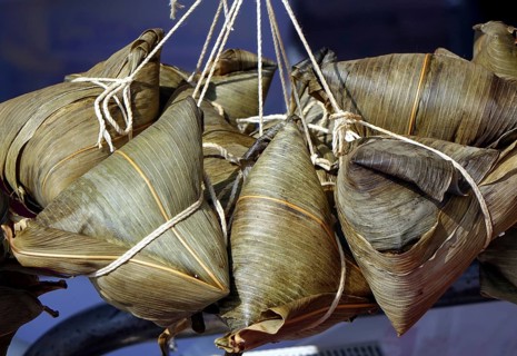 Steamed Chinese sticky rice dumplings wrapped in bamboo leaves