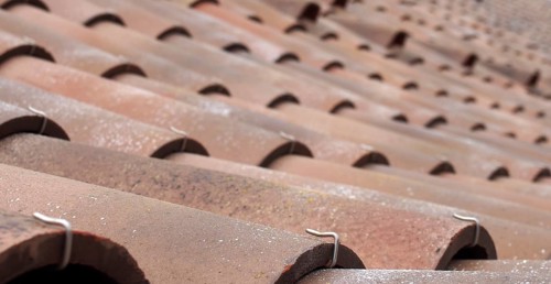 A selective focus perspective view of traditional portuguese curved clay roof tiles