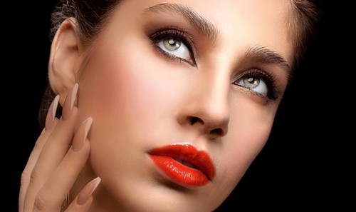 Beautiful facial shot of a female model with expressive eyes and red lips