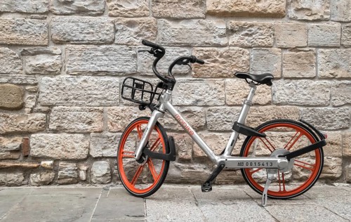 Mobike bicycle meant for bike sharing, parked in public area. Mobike a popular bike sharing