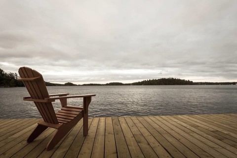 Known as Muskoka or Adirondack chairs sit on a dock at a resort in Muskoka, Ontario, Canada, North