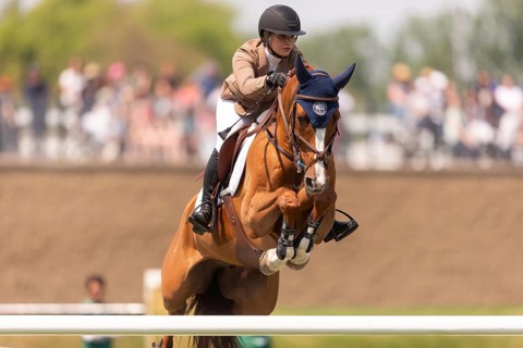 Elena A. Haas, from the United States and riding Claude, compete in the 1.60m Grand Prix during The