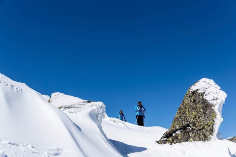 Sofia, Bulgaria - March 12, 2016: Two free riders are prepairing for skiing down a snowy rocky