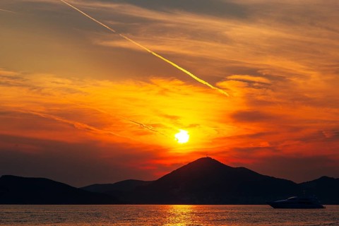 Sunset in Montenegro over the mountains and the sea. Orange sunsets