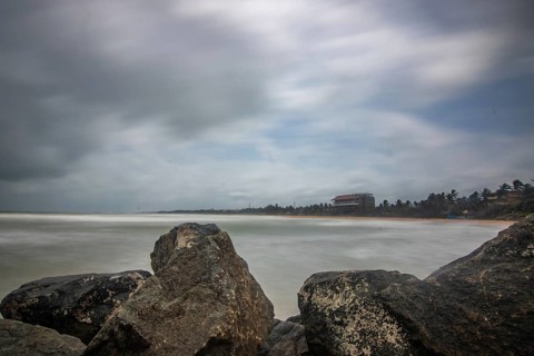 Beach, with lava rocks and vegetation, view of the sea in the evening at sunset. Landscape with