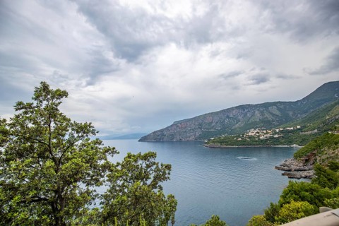 Coastal landscape shot. View from a road leading along the sea and through a breathtaking green