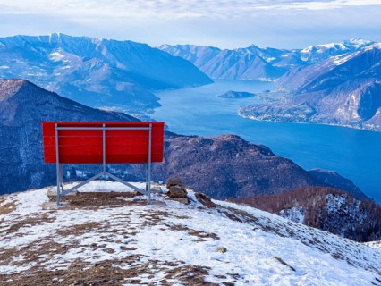 Big red bench on the landscape of Lake Como