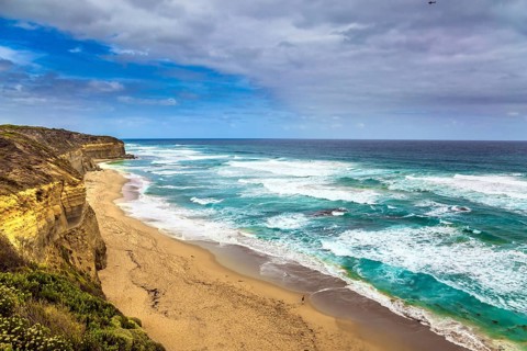 Great Ocean Road of Australia. Picturesque ocean bay with clear green water. The coastal cliffs are