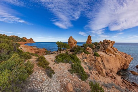 Coastal landscape with bizarre red rocks and sea view, Spiaggia di Cala E'Luas, Ogliastra,