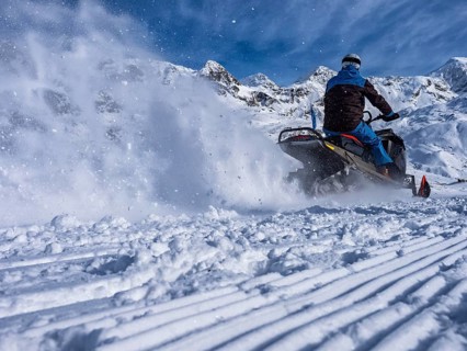 Snowmobile on a trail in the Italian alps