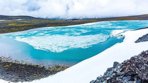 Galdhøpiggen snow-covered in summer in Jotunheimen Lom in Norway is the largest and highest
