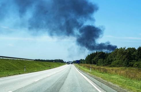 A big fire in the forest near the highway