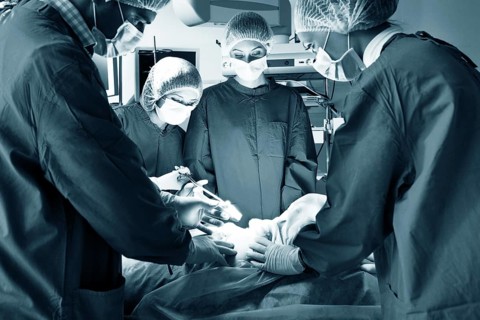 Surgery team operating in a surgical room
