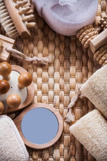 Composition of refreshment skincare items on wicker background sauna concept