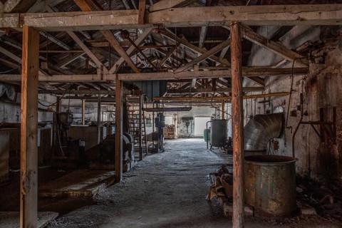 Old abandoned paper factory. Historic and typical factory building as a lost place. Destruction and