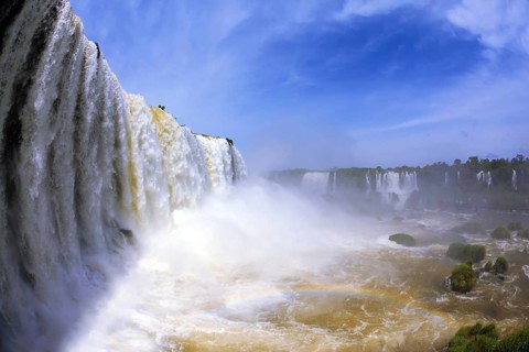 The most high-water waterfall in the world - Iguazu. White whipped foam of water and a thin mist
