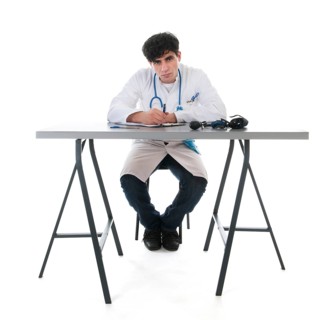 Male doctor with clipboard isolated over white background
