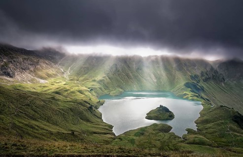 Sunrays through clouds over alpine lake, Schrecksee, Germany, Europe