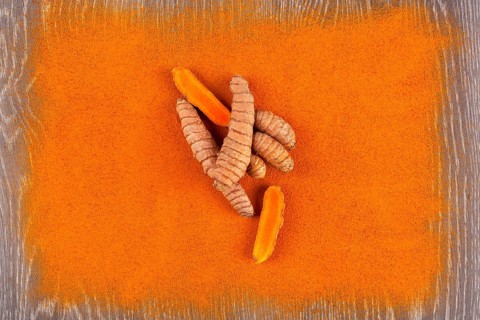 Turmeric root and curcuma spice background. Anti-inflammatory herbal medicine, nutrional supplement