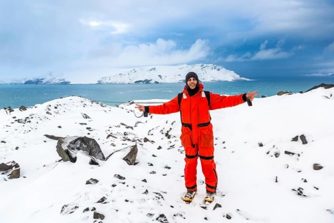 Man walks through ice and snow in Antarctica. Icebergs and everything frozen around you. Cold