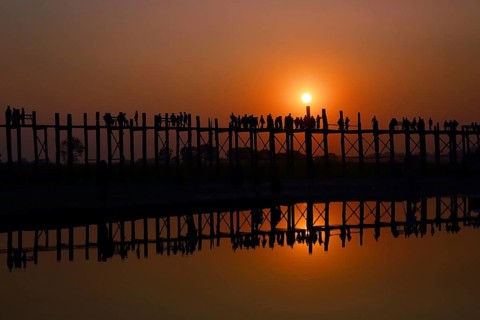 Famous U-Bein teak bridge at sunset on Taungthaman lake in Amarapura, Mandalay division, Myanmar,