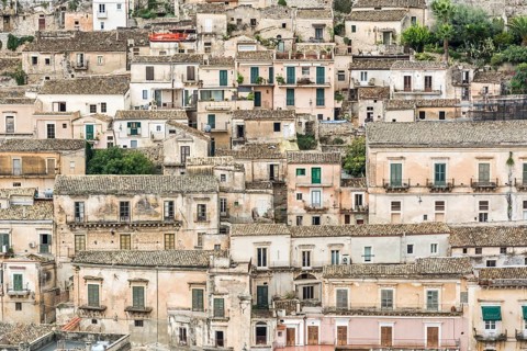 Typical ancient and picturesque town houses on a hill in Italy in the city of Modica on Sicily