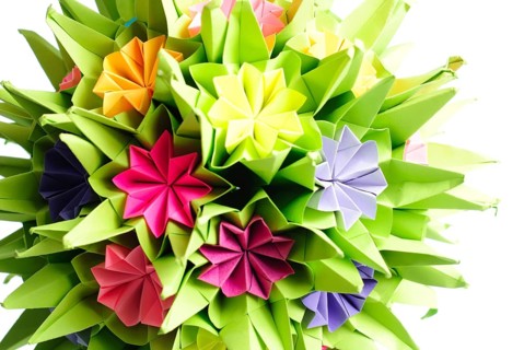 Colorfull origami kusudama from rainbow flowers isolated on white