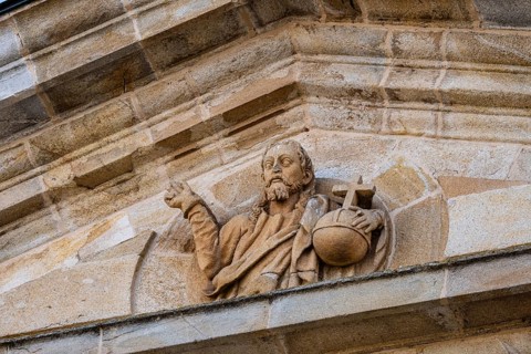 Detail of the pediment of the entrance portico of Zamora Cathedral with sculpture of Christ holding