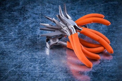 Composition of insulated electric gripping tongs nippers top view image