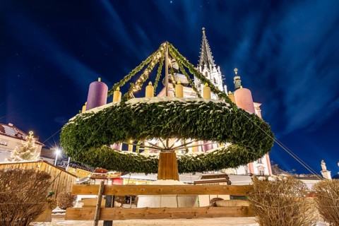 World's largest hanging Advent wreath, behind the basilica, main square of Mariazell, blue hour in
