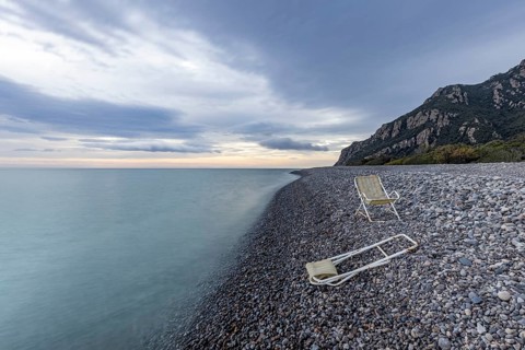 Lonely, deserted, deserted beach with two abandoned deckchairs, long exposure, Coccorocci,